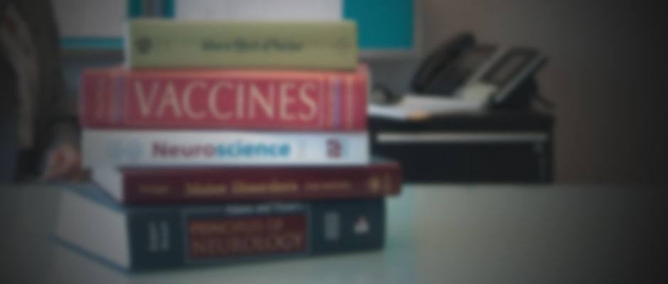 Blurred Stack of Vaccine Injury Textbooks