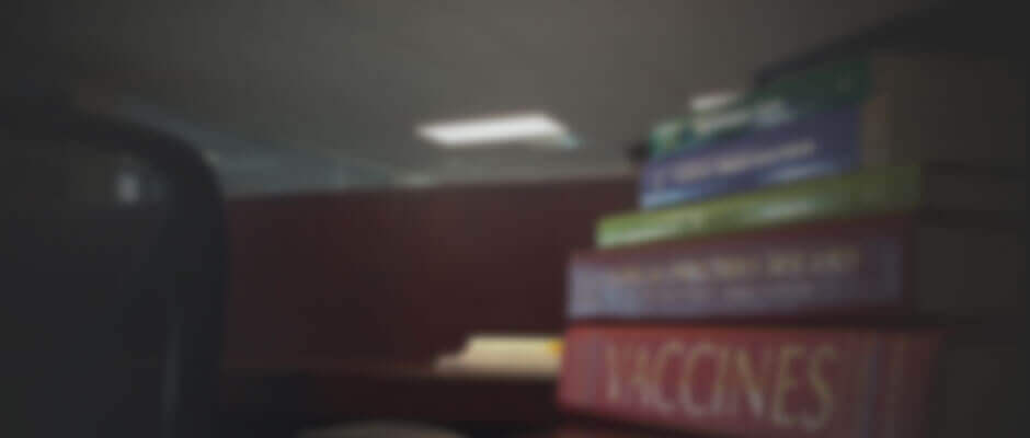 Blurred image of a pile of textbooks on vaccine injury compensation
