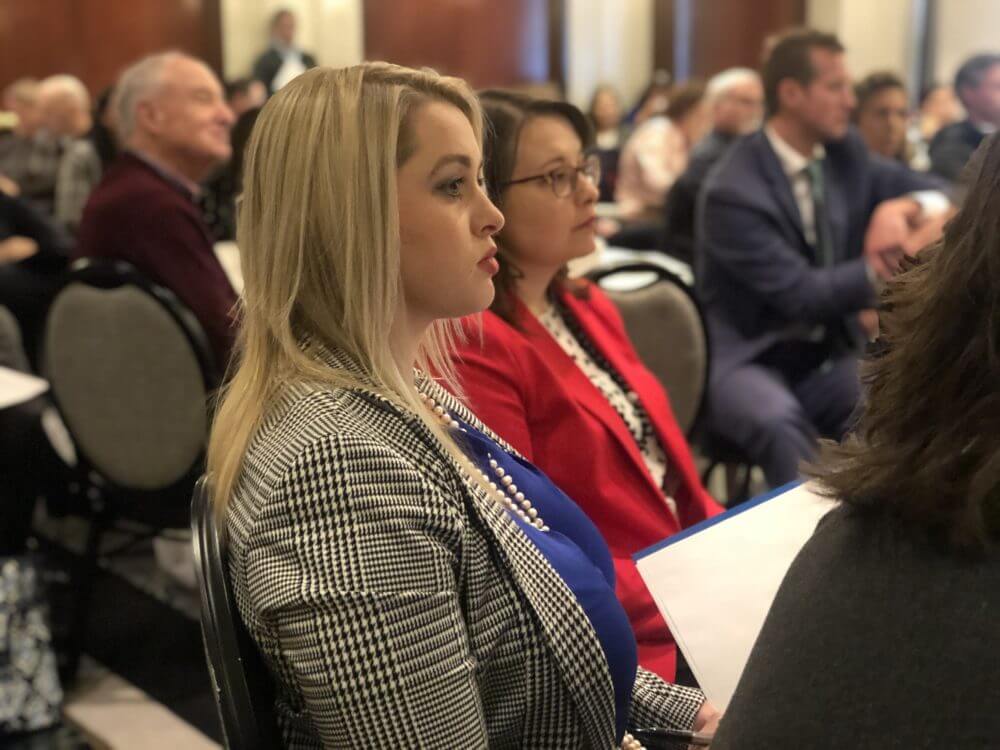 MCTLaw attorneys Jessica Olins and Danielle Strait sitting and watching presentation