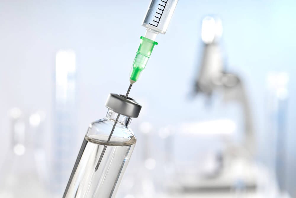 Syringe Drawing Vaccine out of Vial 